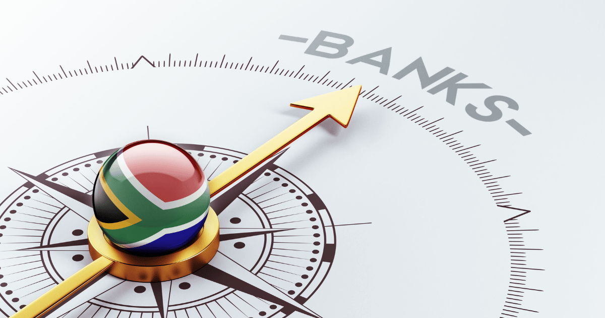 A dial pointing at the word bank with a South African flag at the core of the dial